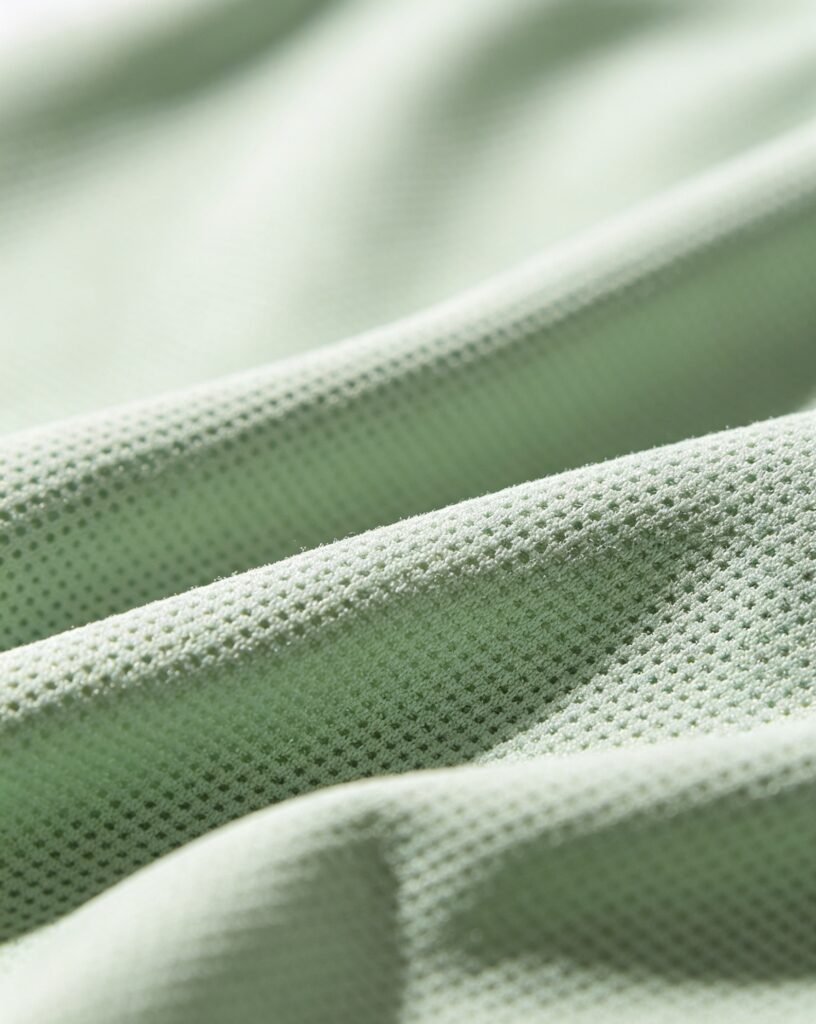 high quality fabric for polo Custom Mens Womens Golf Apparel Manufacturers China Custom Mens Womens Golf Apparel Manufacturers China Close up of breathable recycled polyester golf fabric stretch golf clothing material textile inspection macro shot premium sportswear fabric detail